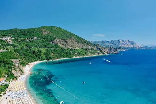 Stunning aerial drone view of a coastal beach in Montenegro with turquoise waters.