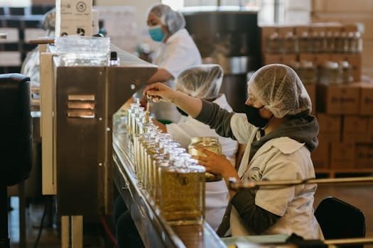 Women workers process tequila bottles on a production line inside a Mexican distillery.