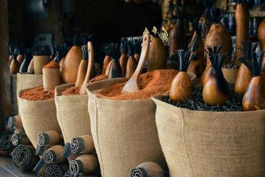 Colorful spice sacks and traditional containers in a Bukhara market.